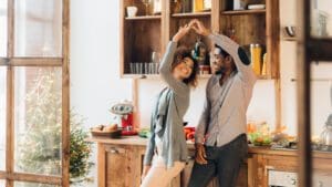 couple dancing in the kitchen smiling at each other
